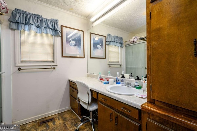 bathroom with vanity, ornamental molding, and a textured ceiling