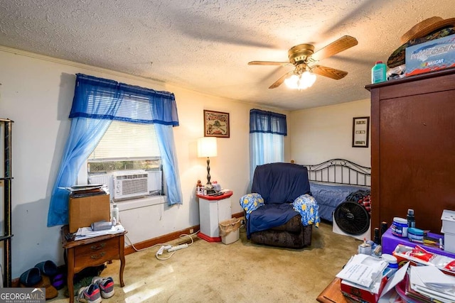 bedroom featuring cooling unit, ceiling fan, carpet flooring, and a textured ceiling