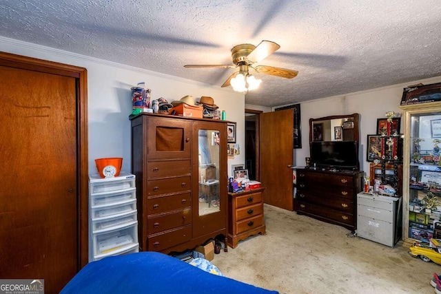 carpeted bedroom with ceiling fan, a textured ceiling, and crown molding