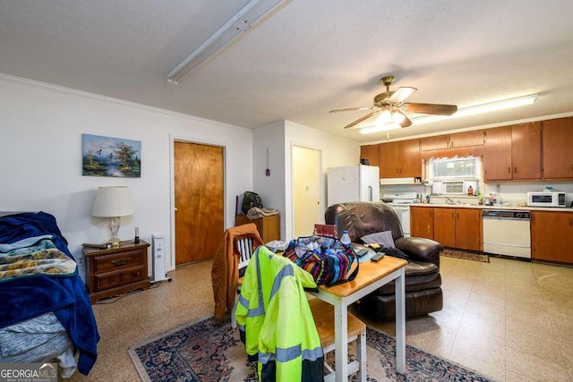 dining space featuring ceiling fan, a textured ceiling, and ornamental molding