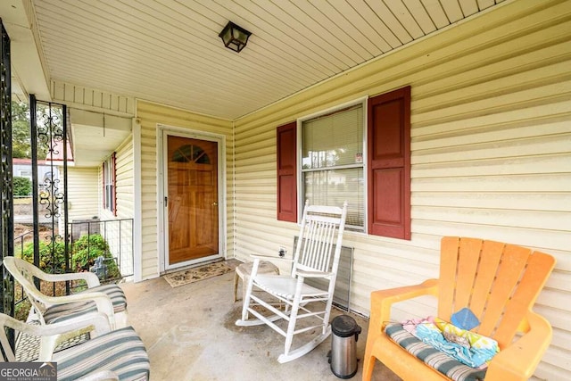 view of exterior entry with a porch