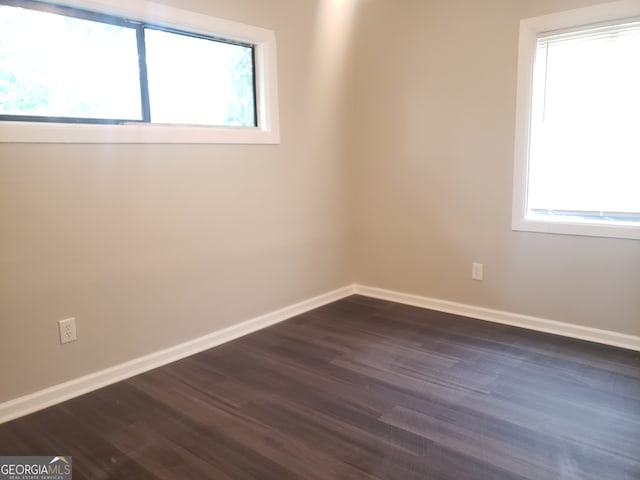 spare room featuring dark hardwood / wood-style flooring