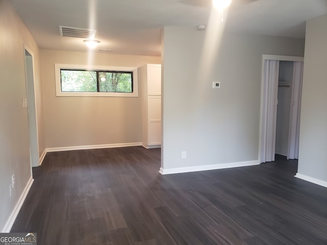 empty room featuring dark wood-type flooring