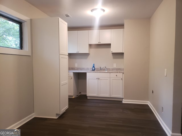 kitchen featuring white cabinets, sink, and dark hardwood / wood-style flooring