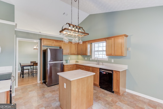 kitchen featuring stove, sink, stainless steel refrigerator, a center island, and black dishwasher