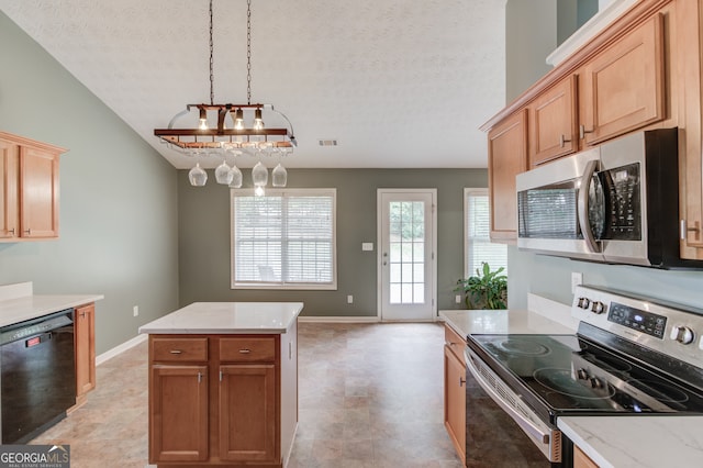 kitchen featuring a notable chandelier, a center island, a textured ceiling, and appliances with stainless steel finishes