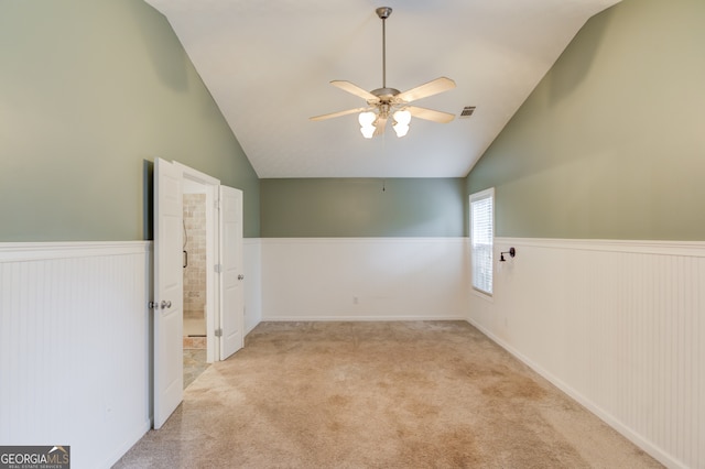 bonus room with light carpet, lofted ceiling, and ceiling fan