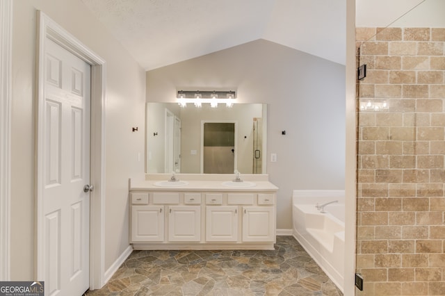 bathroom featuring independent shower and bath, vanity, and lofted ceiling