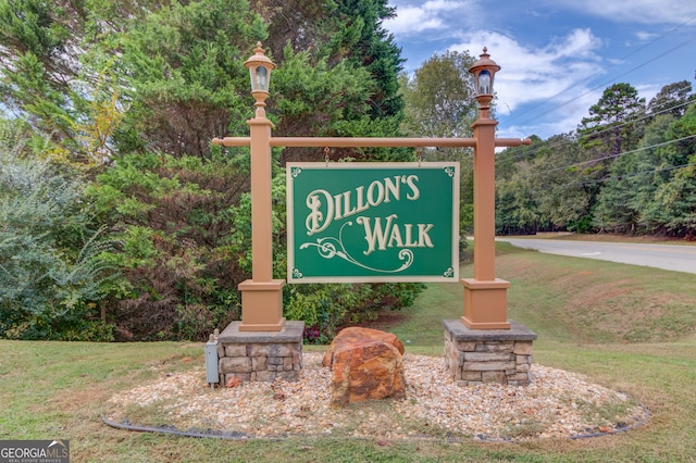 community sign featuring a lawn