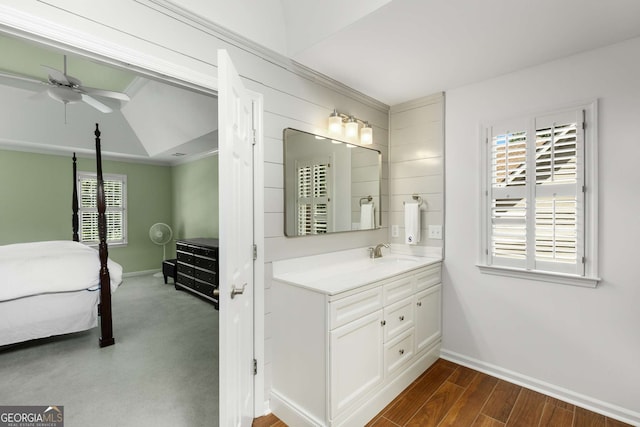 bathroom with a wealth of natural light, hardwood / wood-style floors, ceiling fan, and vanity