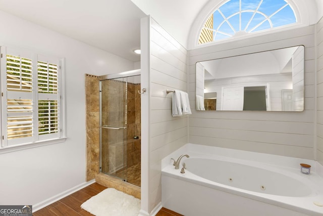 bathroom with independent shower and bath and wood-type flooring