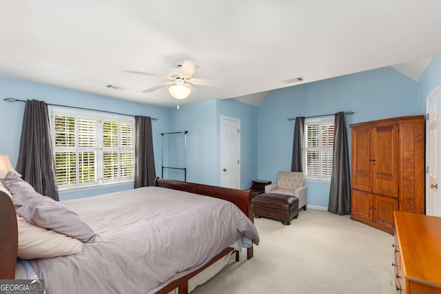 carpeted bedroom featuring multiple windows and ceiling fan