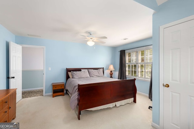 bedroom with ceiling fan and light carpet