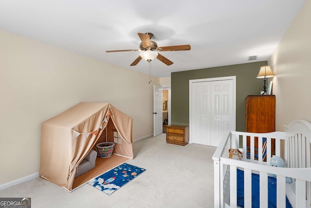 carpeted bedroom with a closet and ceiling fan