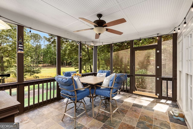 sunroom / solarium featuring ceiling fan