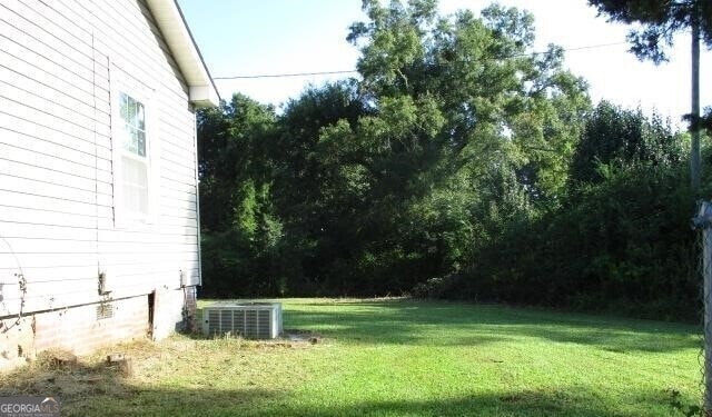 view of yard with central AC