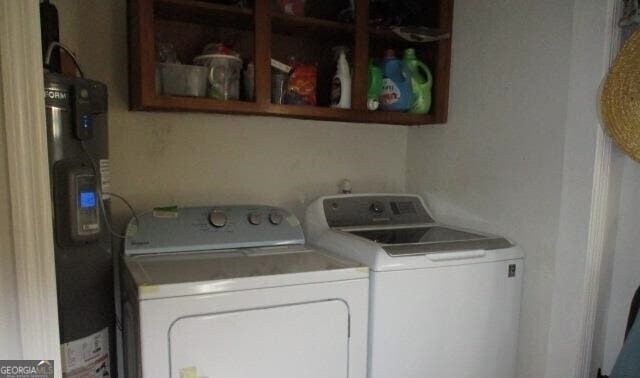 clothes washing area featuring separate washer and dryer