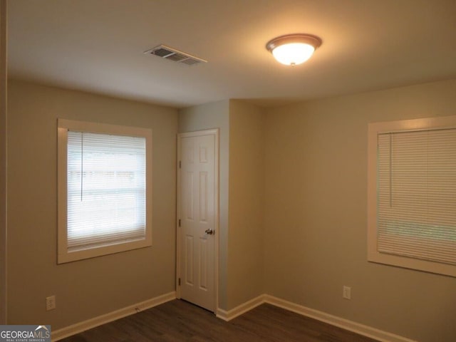 973 Neal St NW, Atlanta, GA 30314 - spare room featuring dark wood-type flooring, visible vents, and baseboards