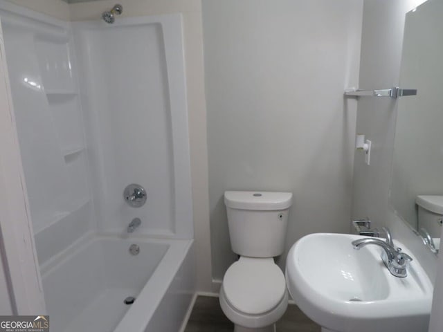 973 Neal St NW, Atlanta, GA 30314 - bathroom featuring toilet, shower / tub combination, a sink, and baseboards