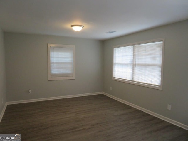 empty room with dark wood-type flooring