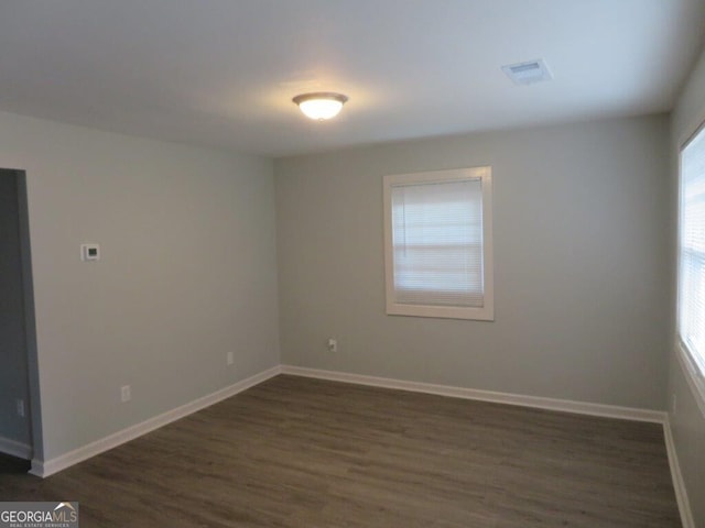 spare room featuring dark hardwood / wood-style floors