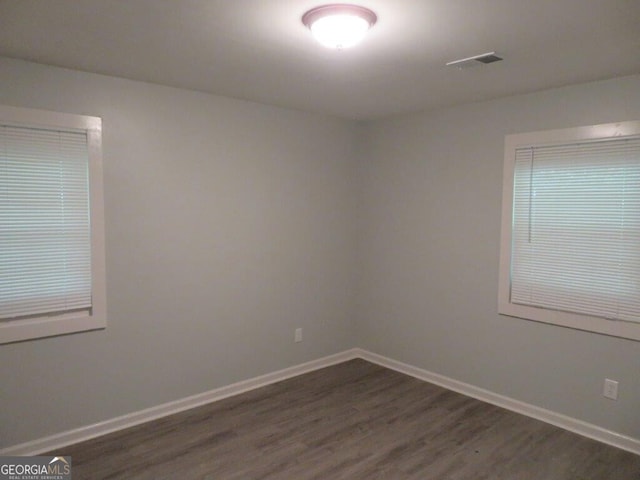 973 Neal St NW, Atlanta, GA 30314 - spare room with visible vents, baseboards, and dark wood-style floors
