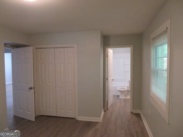 973 Neal St NW, Atlanta, GA 30314 - unfurnished bedroom with a closet, baseboards, and wood finished floors