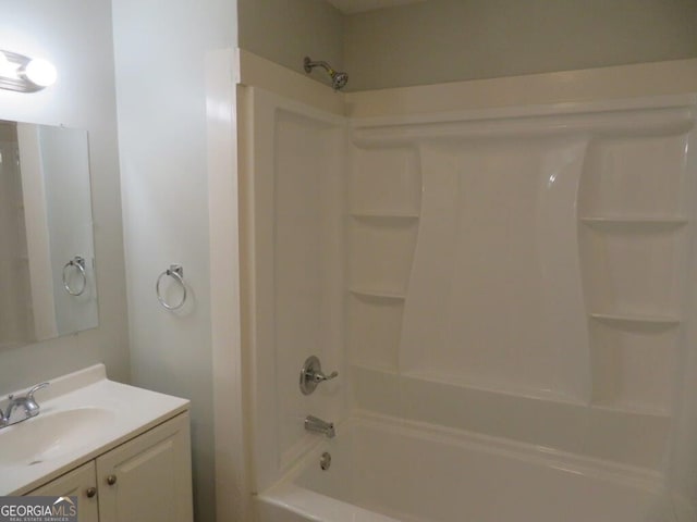 bathroom featuring  shower combination and vanity