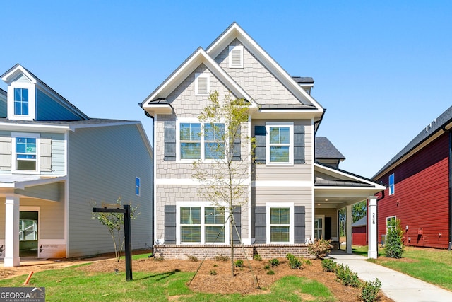 craftsman house featuring a carport and a front yard