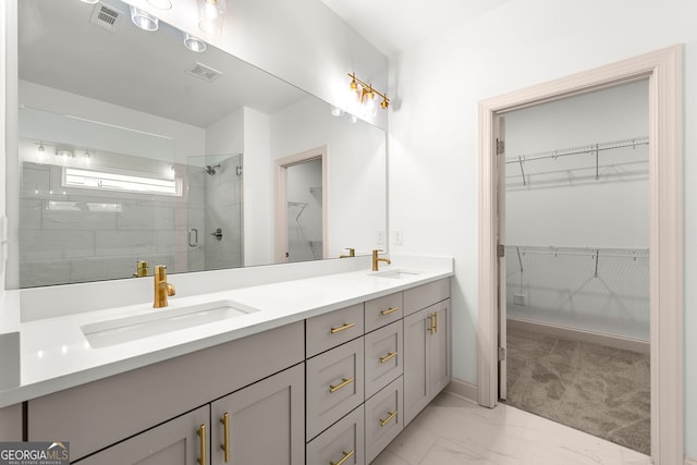 bathroom with vanity and a shower with shower door