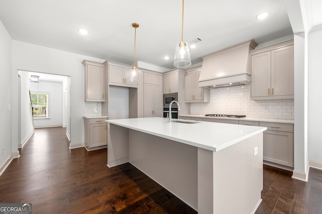 kitchen featuring a kitchen island with sink, custom range hood, and dark hardwood / wood-style flooring