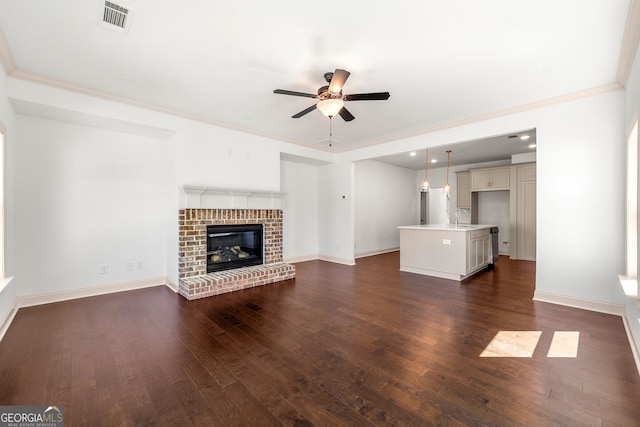 unfurnished living room with sink, ceiling fan, crown molding, and dark hardwood / wood-style flooring