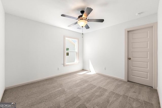 carpeted empty room featuring ceiling fan