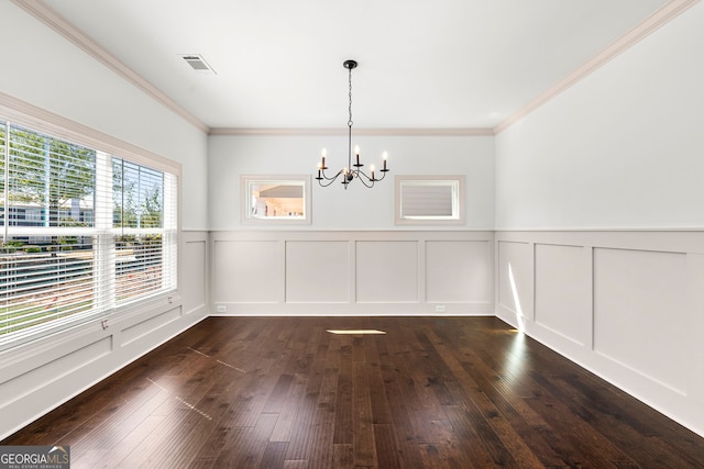 unfurnished dining area with ornamental molding, a notable chandelier, and dark hardwood / wood-style flooring