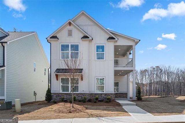 view of front of home featuring a balcony and central AC