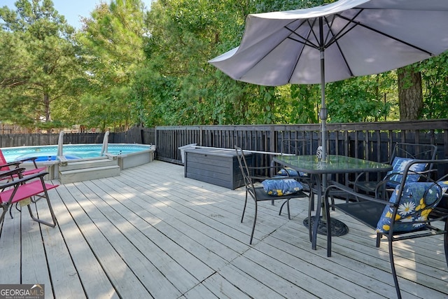 deck featuring a fenced in pool