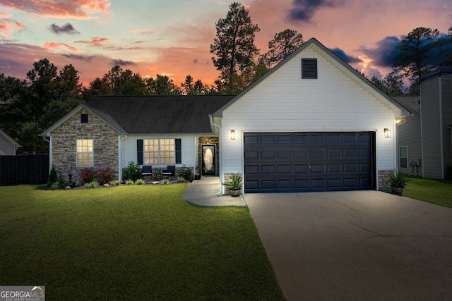 view of front of house with a yard and a garage