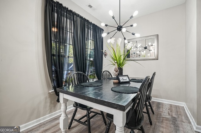 dining room with an inviting chandelier and hardwood / wood-style floors