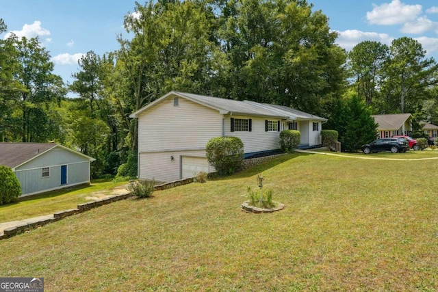 single story home featuring a garage and a front lawn