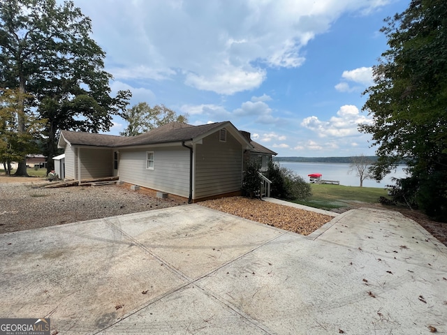 view of side of home with a water view