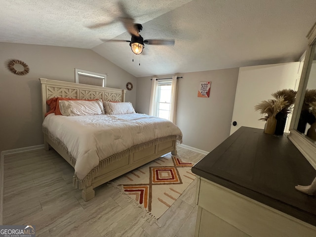 bedroom featuring a textured ceiling, vaulted ceiling, and ceiling fan