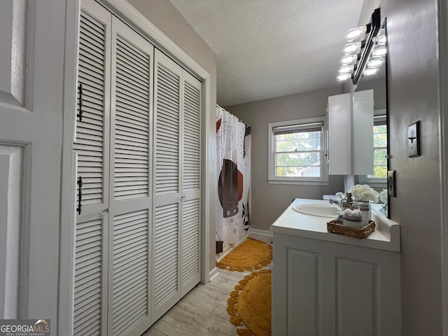 laundry area featuring sink and a textured ceiling