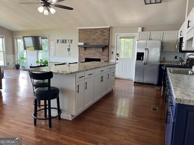 kitchen featuring white cabinets, a center island, and appliances with stainless steel finishes