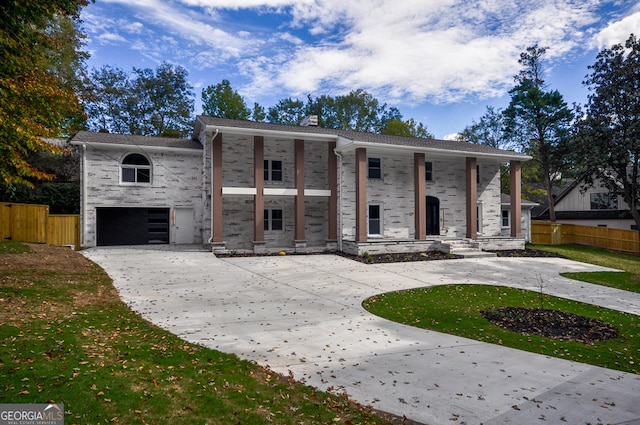 view of front of house featuring a front yard and a garage