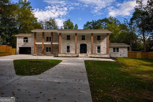 view of front of home featuring a garage and a front lawn