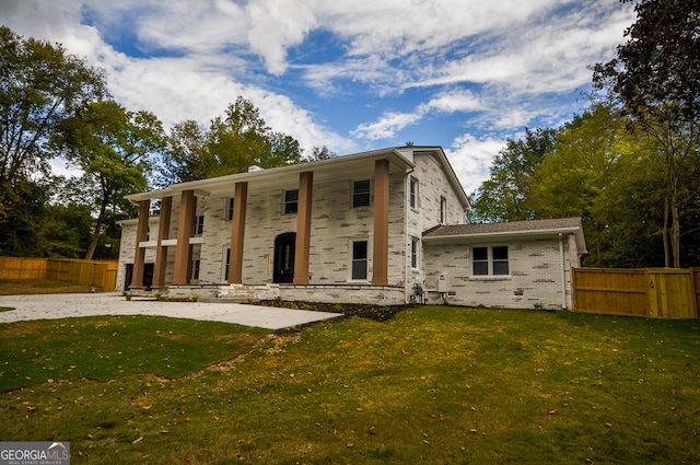 view of front of property with a patio and a front yard