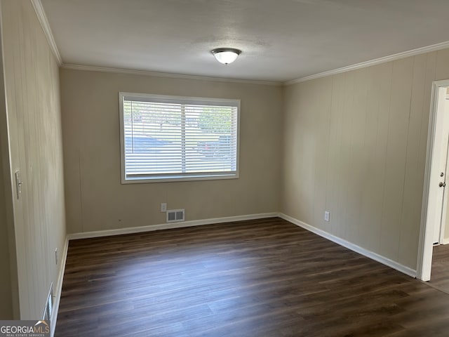 spare room with dark hardwood / wood-style floors and crown molding