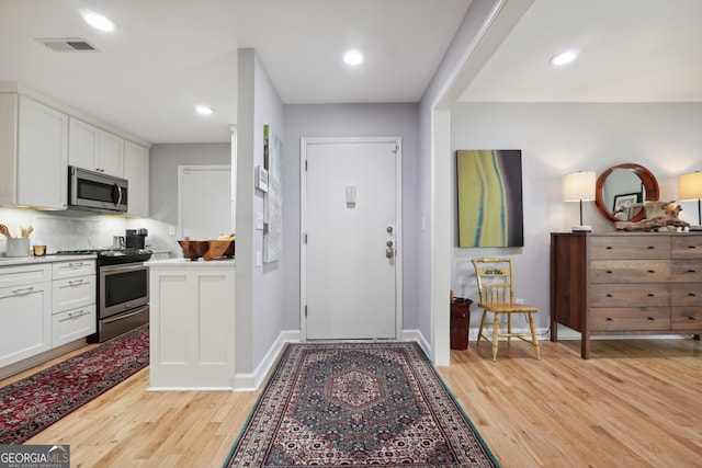 foyer entrance with light hardwood / wood-style flooring