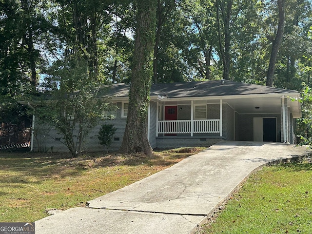 ranch-style house with a front yard, covered porch, and a carport