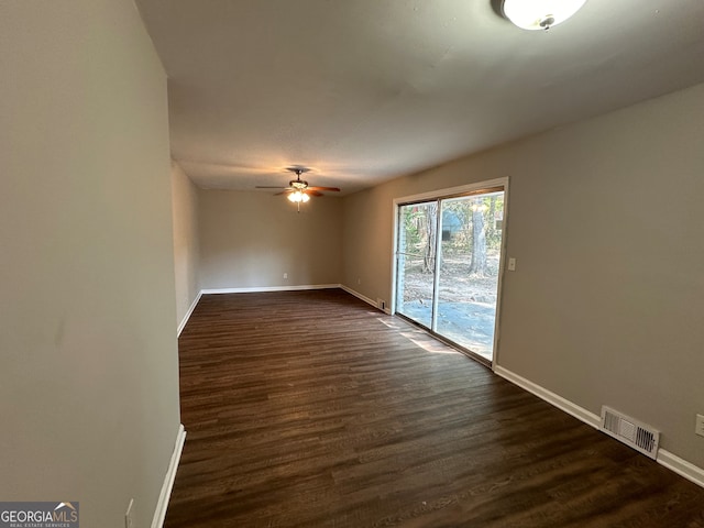 spare room featuring ceiling fan and dark hardwood / wood-style flooring